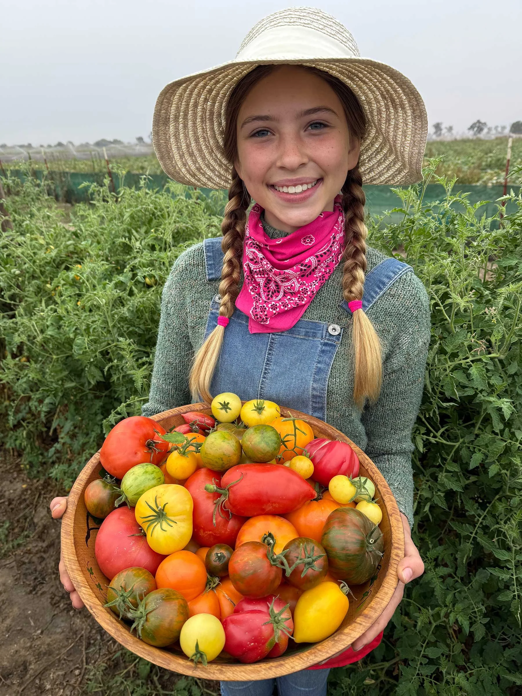 Granddaughter Sage helps with harvest.