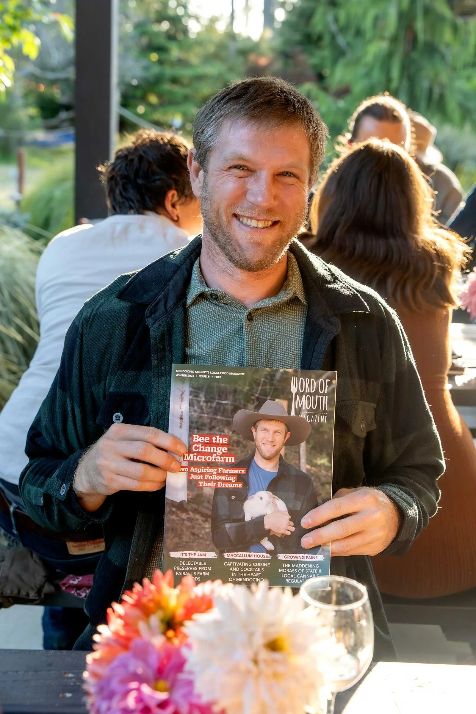  The guy from “Bee the Change Microfarm”  on the front page of the word of mouth magazine. 