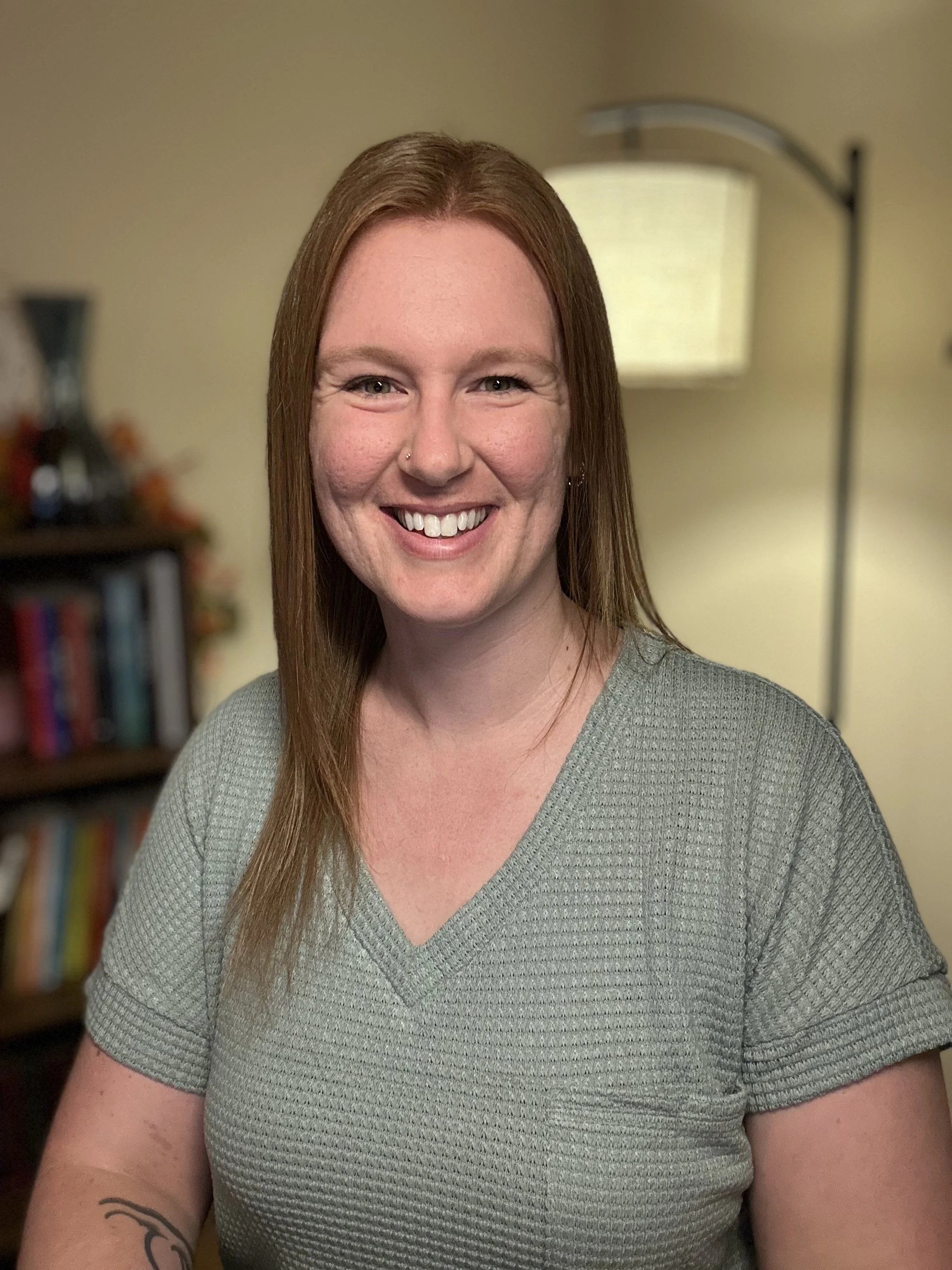 smiling female with red hair who is trauma therapist in Concord, NC