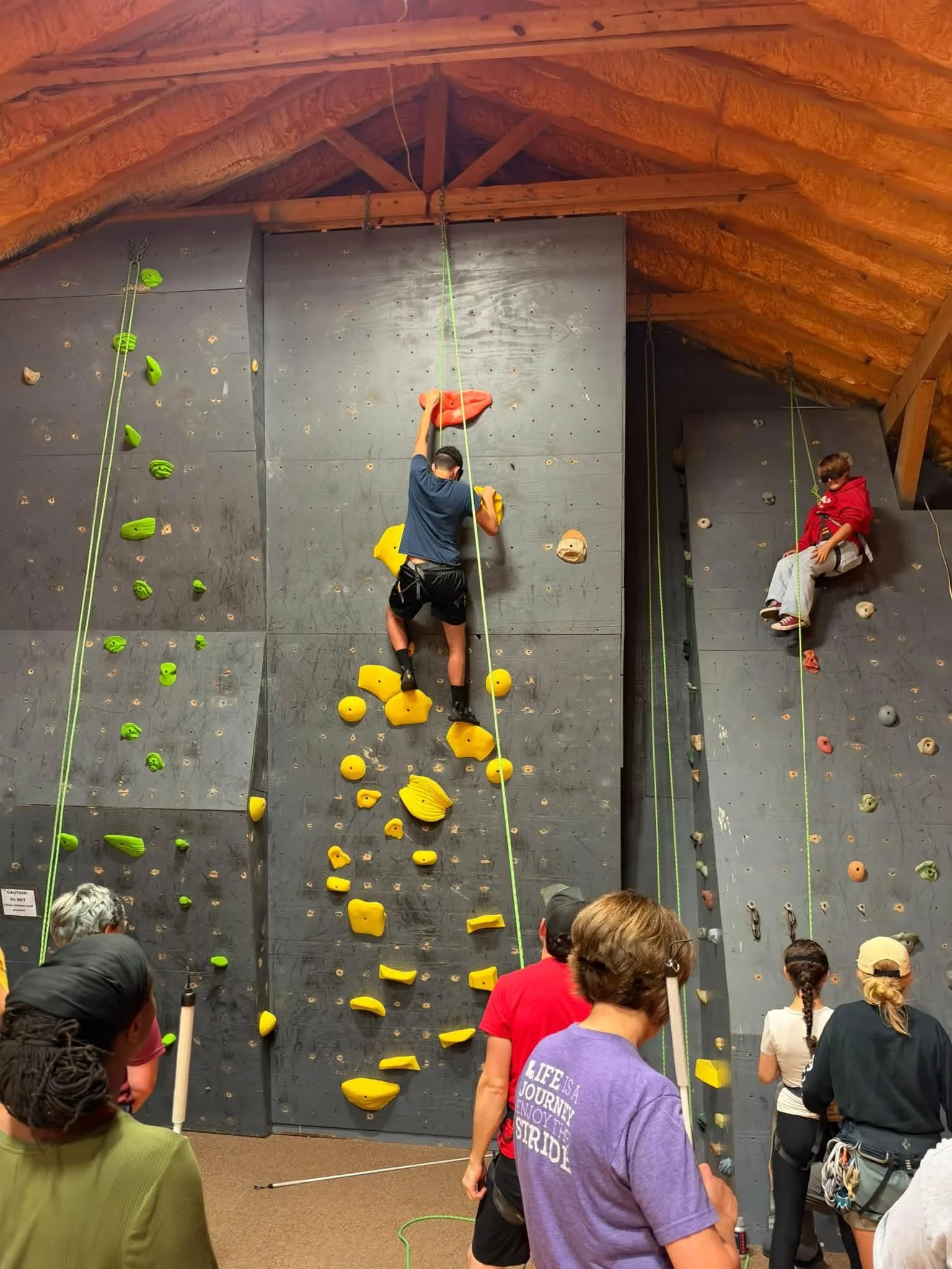 Student climbing rock wall