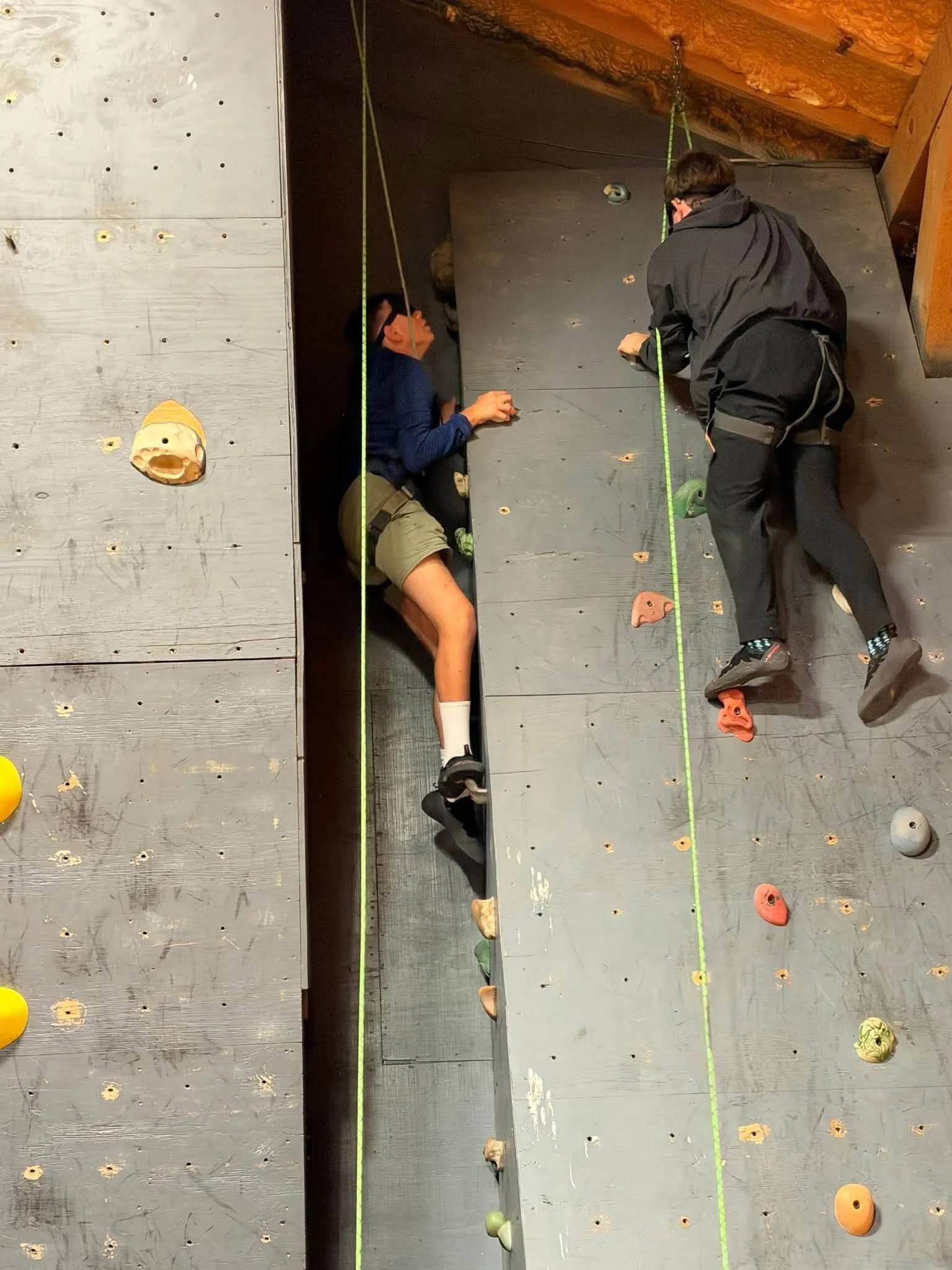 Student climbing rock wall