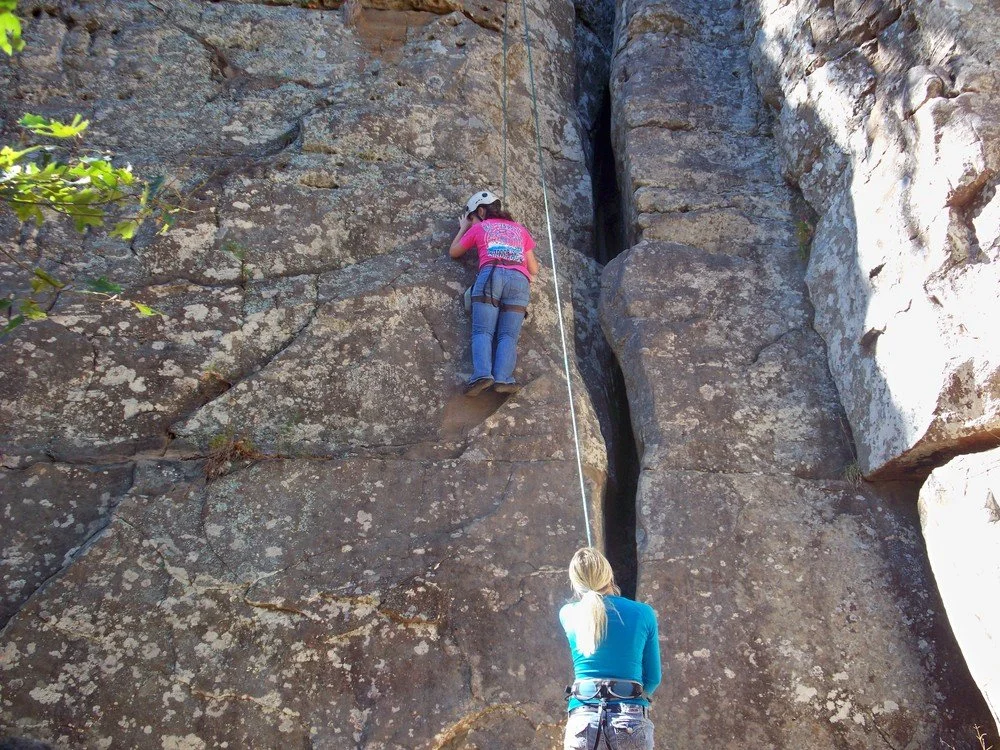 LCB Student mountain climbing with harness