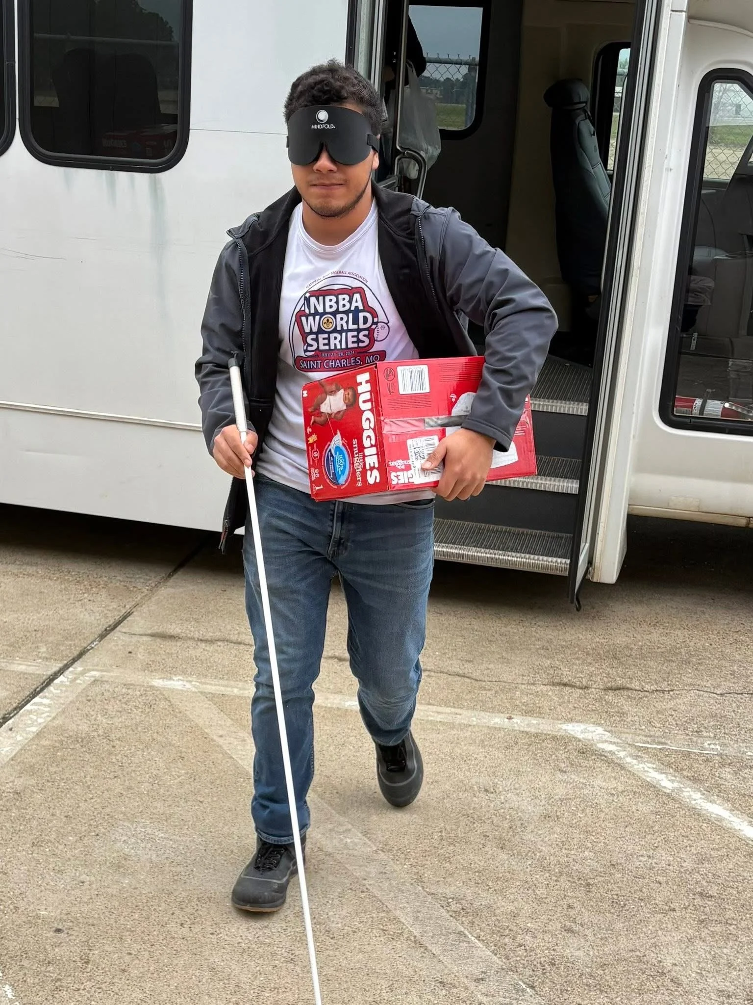 Student donating diapers to local community group