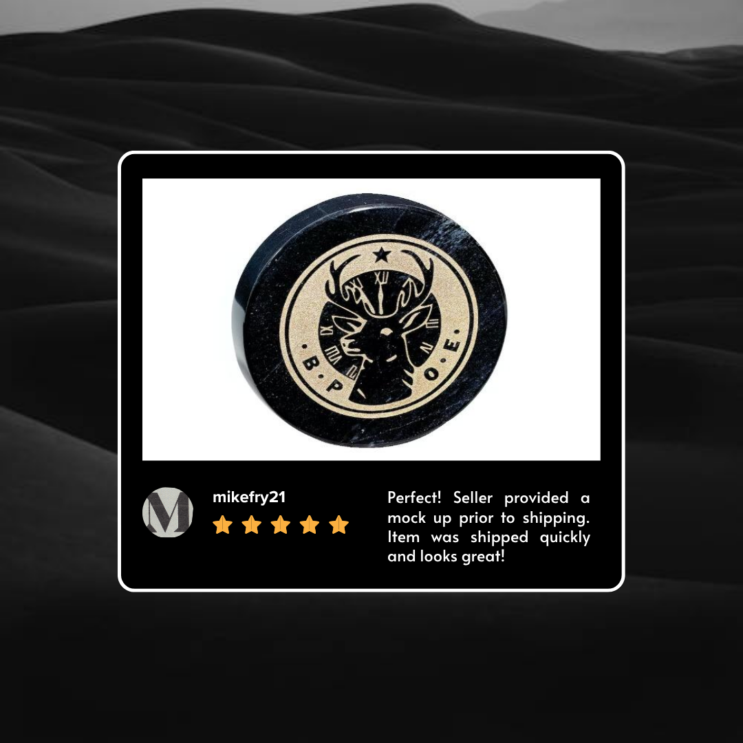 A black round puck with a beige logo featuring a deer's head and Roman numerals around it.