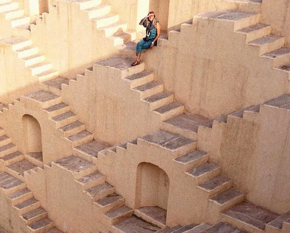 Imogen sat in a traditional Indian water well with lots of staircases inbuilt into the walls.