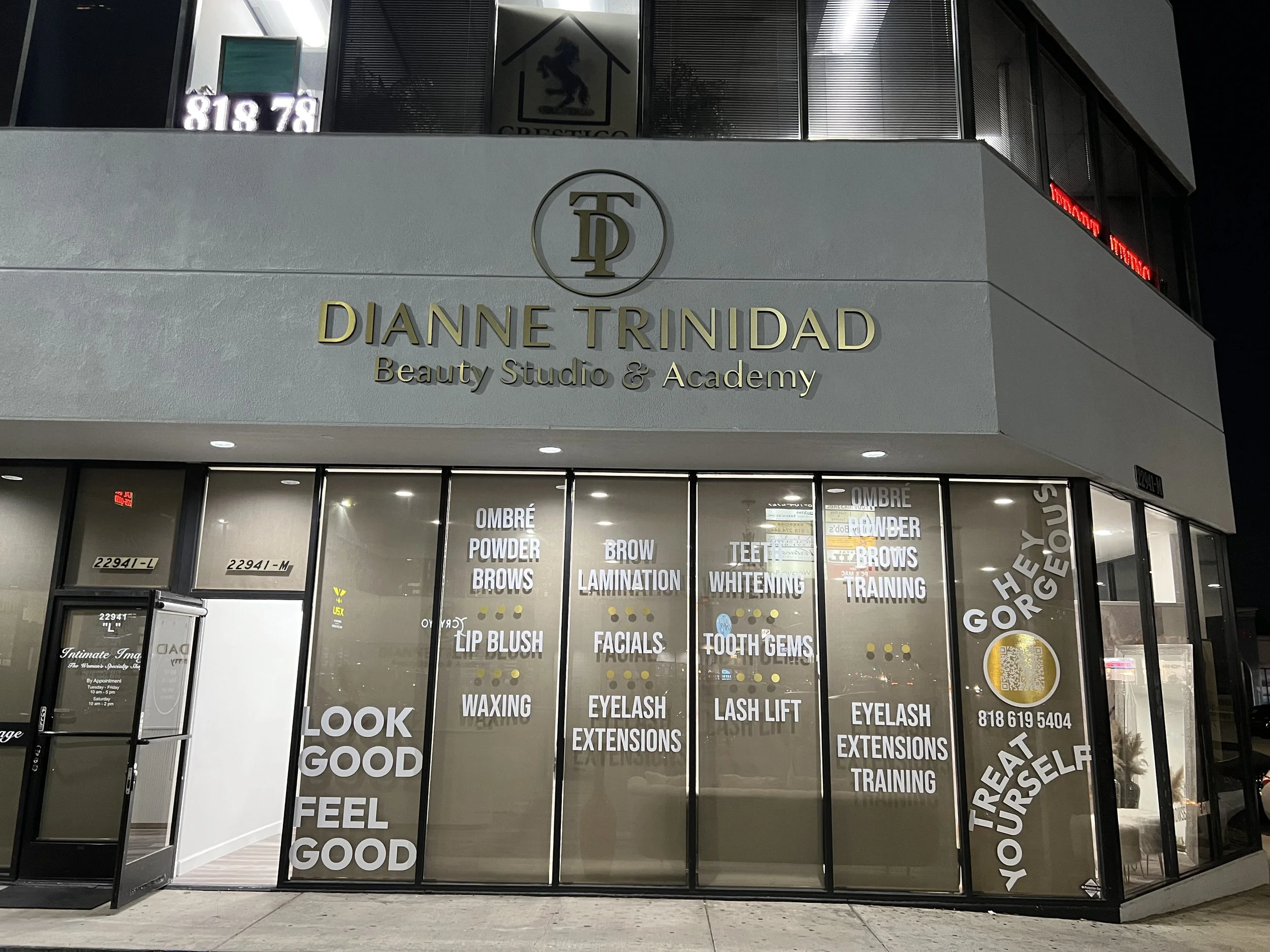 Exterior of Dianne Trinidad Beauty Studio & Academy at night, with large glass windows displaying services such as ombré powder brows, lip blush, waxing, facials, teeth whitening | Grizzly Signs | Los Angeles, CA | Custom Signs