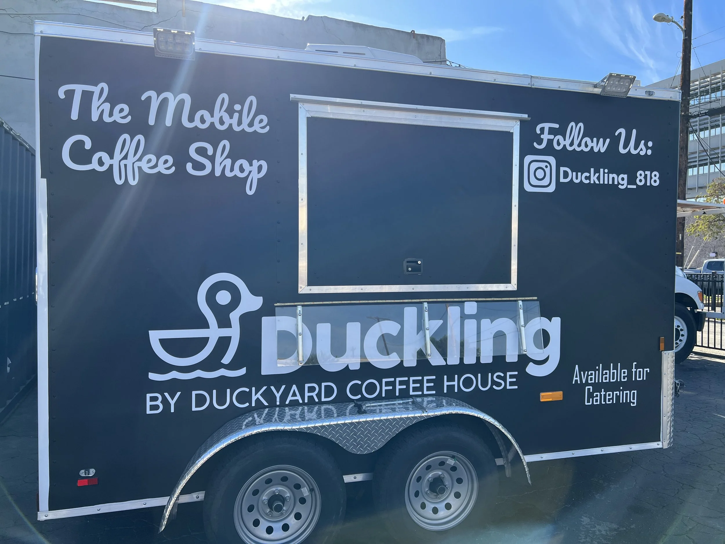 A mobile coffee shop trailer with signage for Ducking by Duckyard Coffee House, featuring social media handle @Duckling_818, | Grizzly Signs | Los Angeles, CA | Custom Wraps