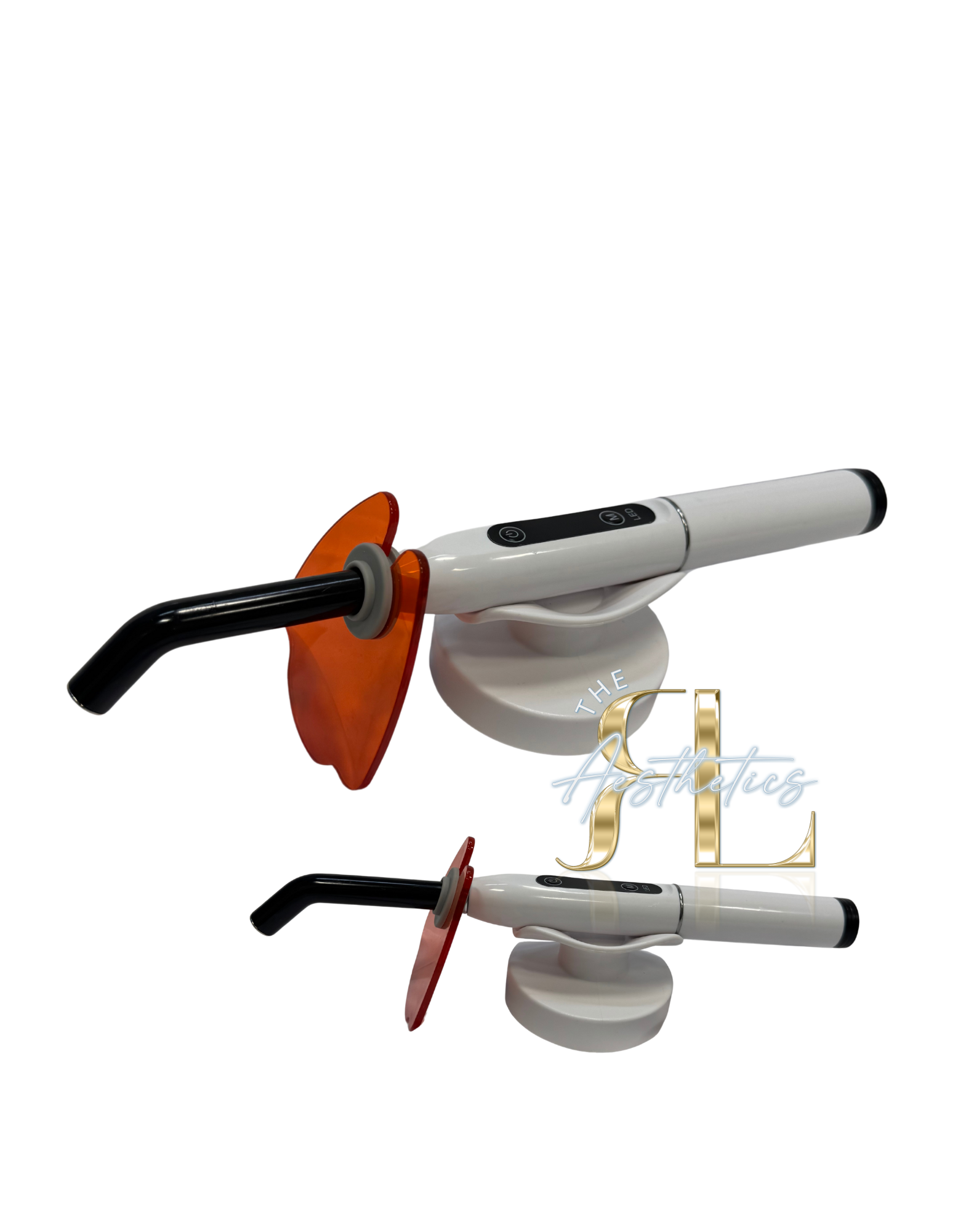 A dental curing light with a black handle, white body, and orange shield, reflected on a mirrored surface with a logo reading 'The Aesthetics'.