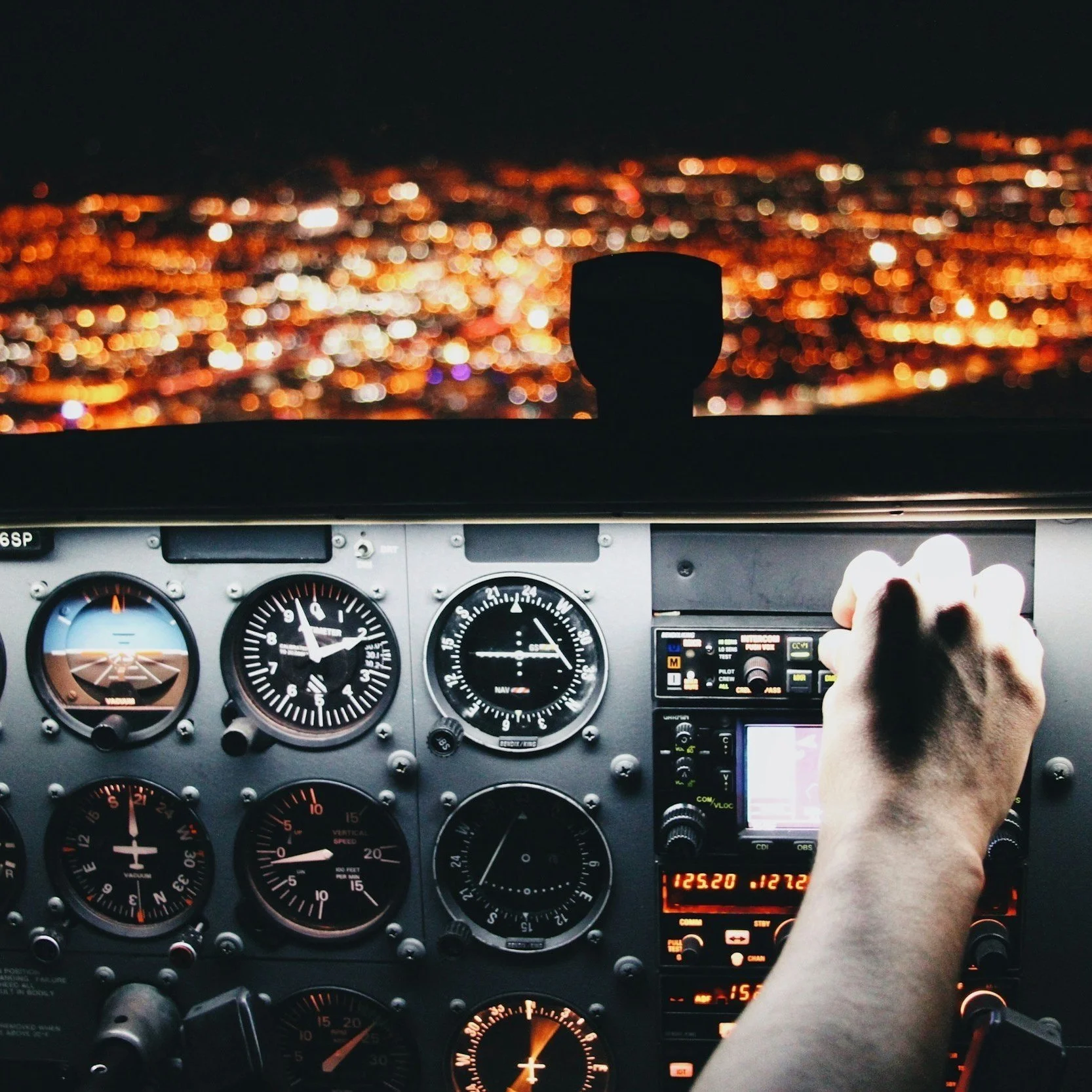 View of airplane cockpit instruments over a city, representing the KPIs a fractional FP&A consultant can develop.