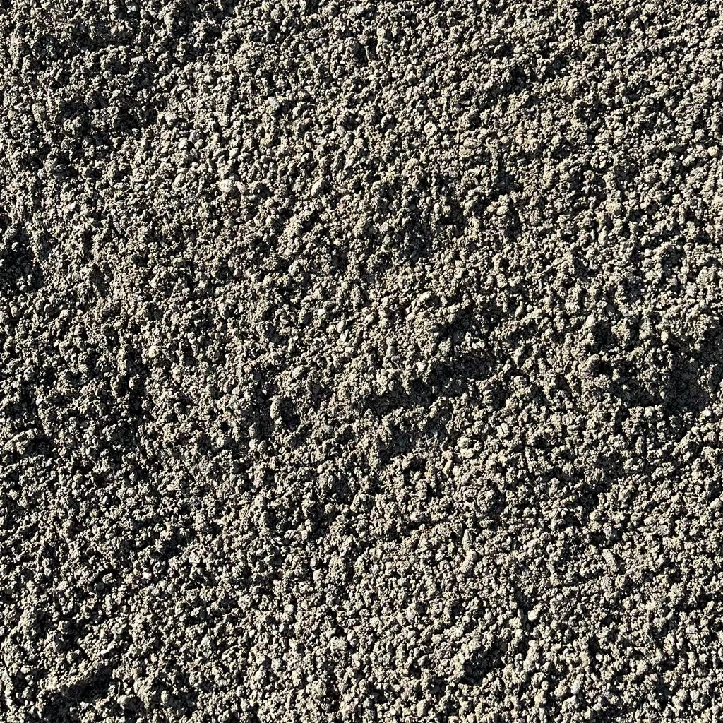 Sand with various footprints and small particles scattered across the surface.