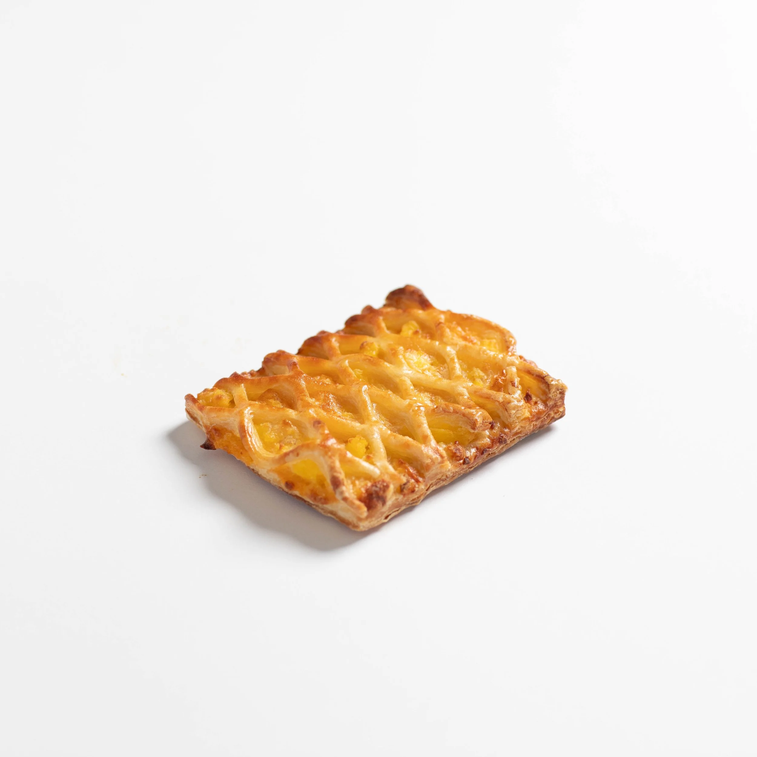 Lattice croissants are filled with savory fillings, frozen and ready to bake for your business