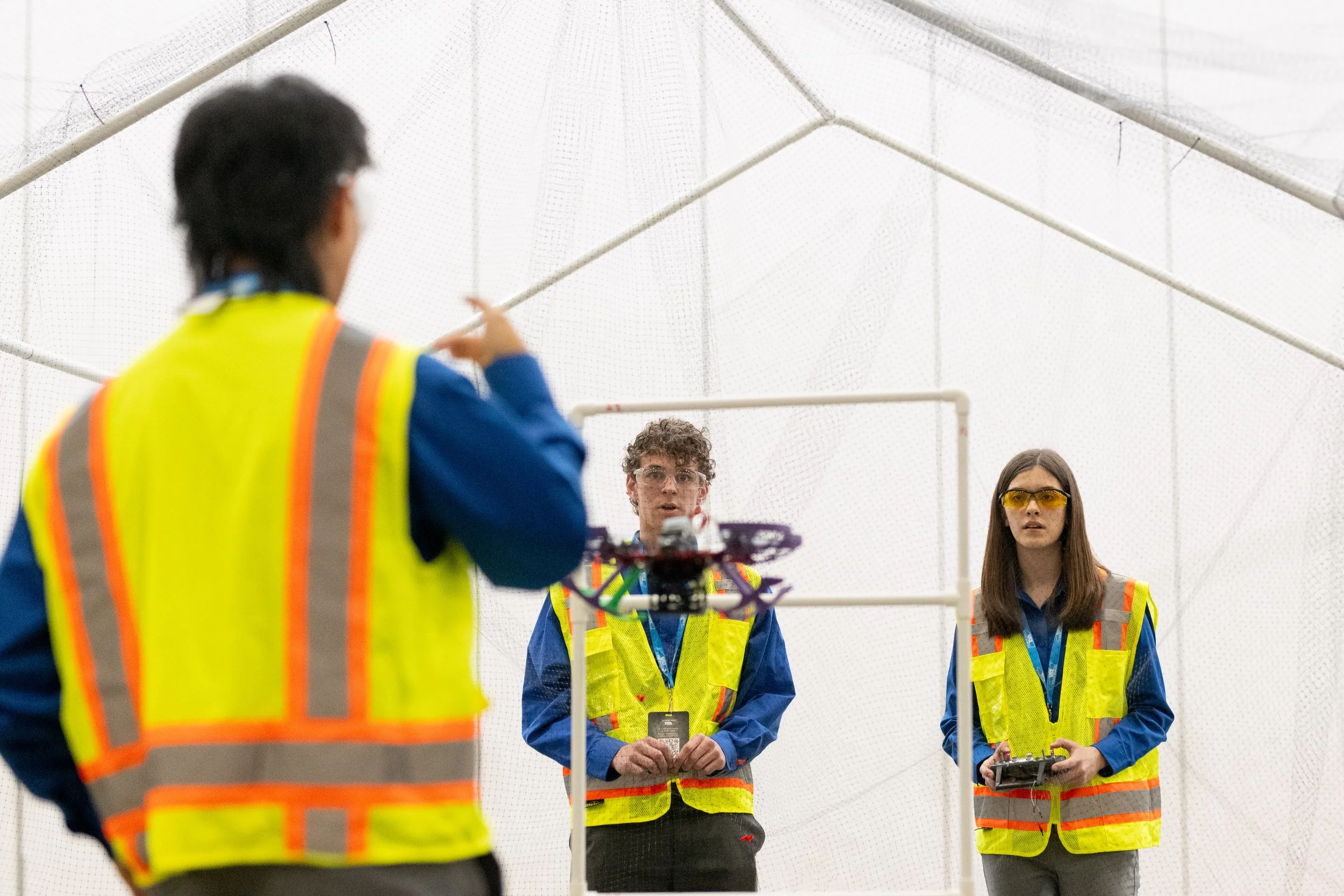A team of TSA competitors work on improving and repair a robot for competition.