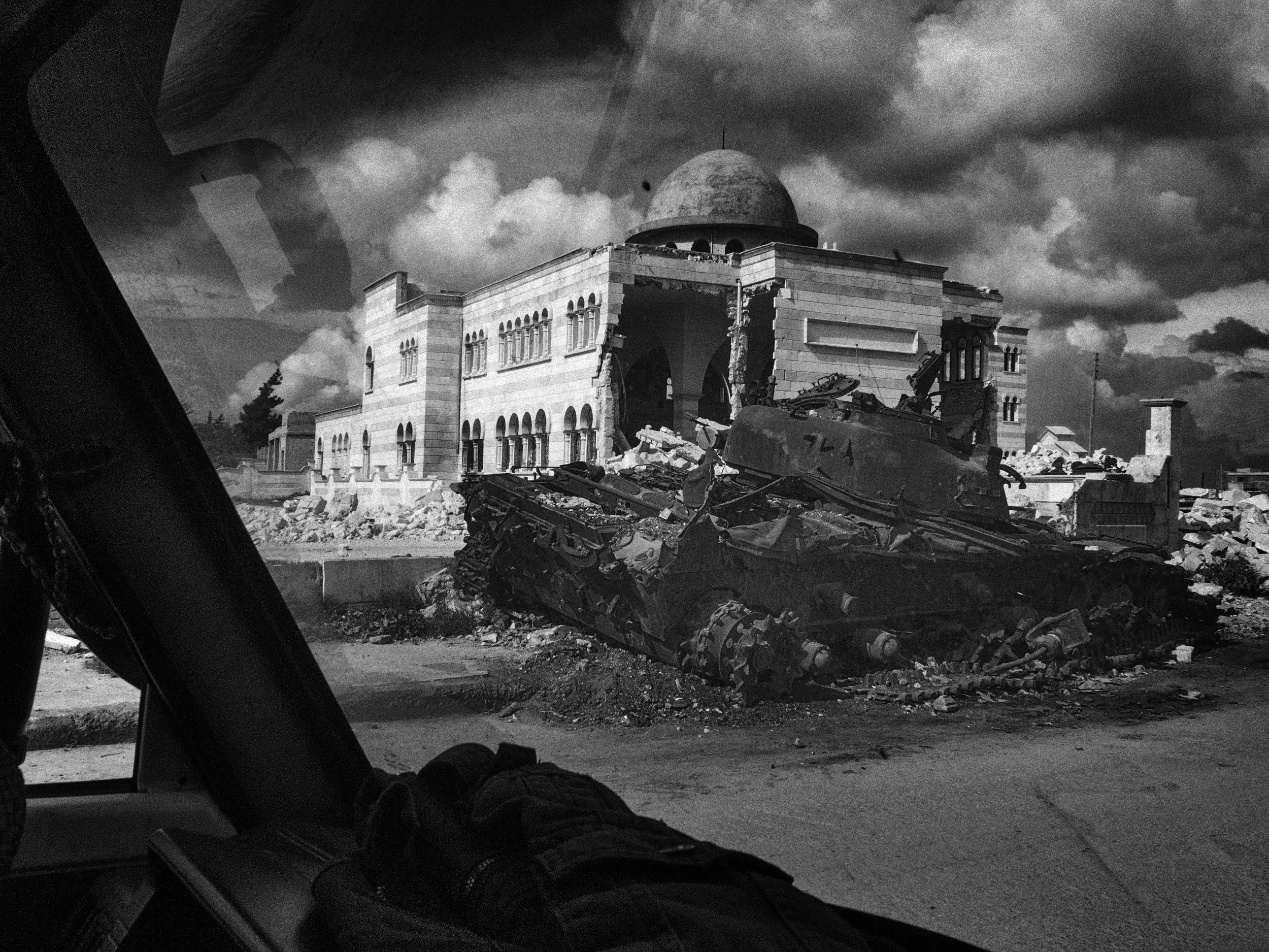 Road To Aleppo. Destroyed tank , and bombed Mosque from a car window.