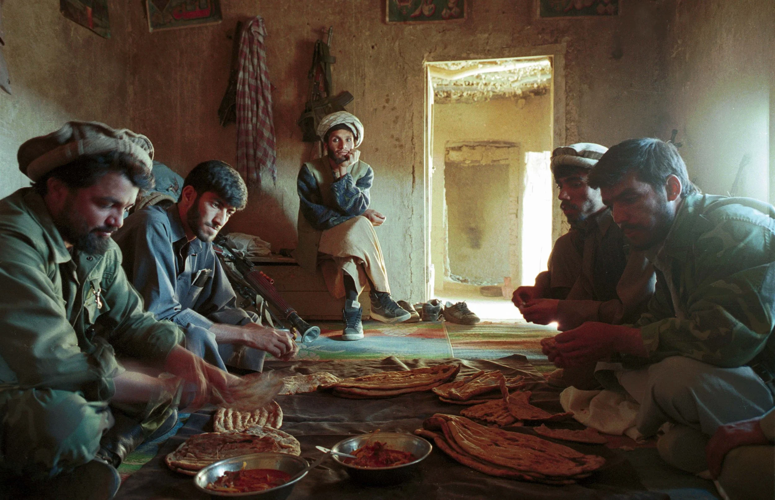 Sinjadarrah Commander Khudamuddin and his fighters sharing a meal. Afghanistan, Autumn 2001
