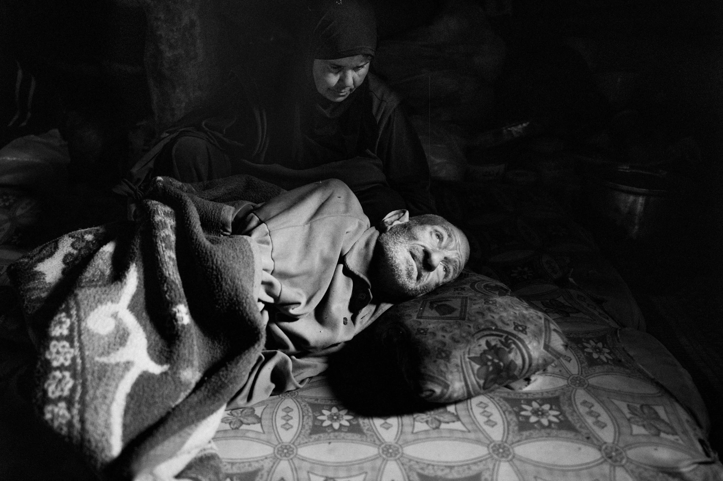 Ismail Khodor al-Yosef is 75 and has a heart that has been worn out by a heart attack, bones that sculpt his skin like a bas-relief, he is lying down on the ground and is waiting to die. Jabal al-Zawiya, Syria 2013