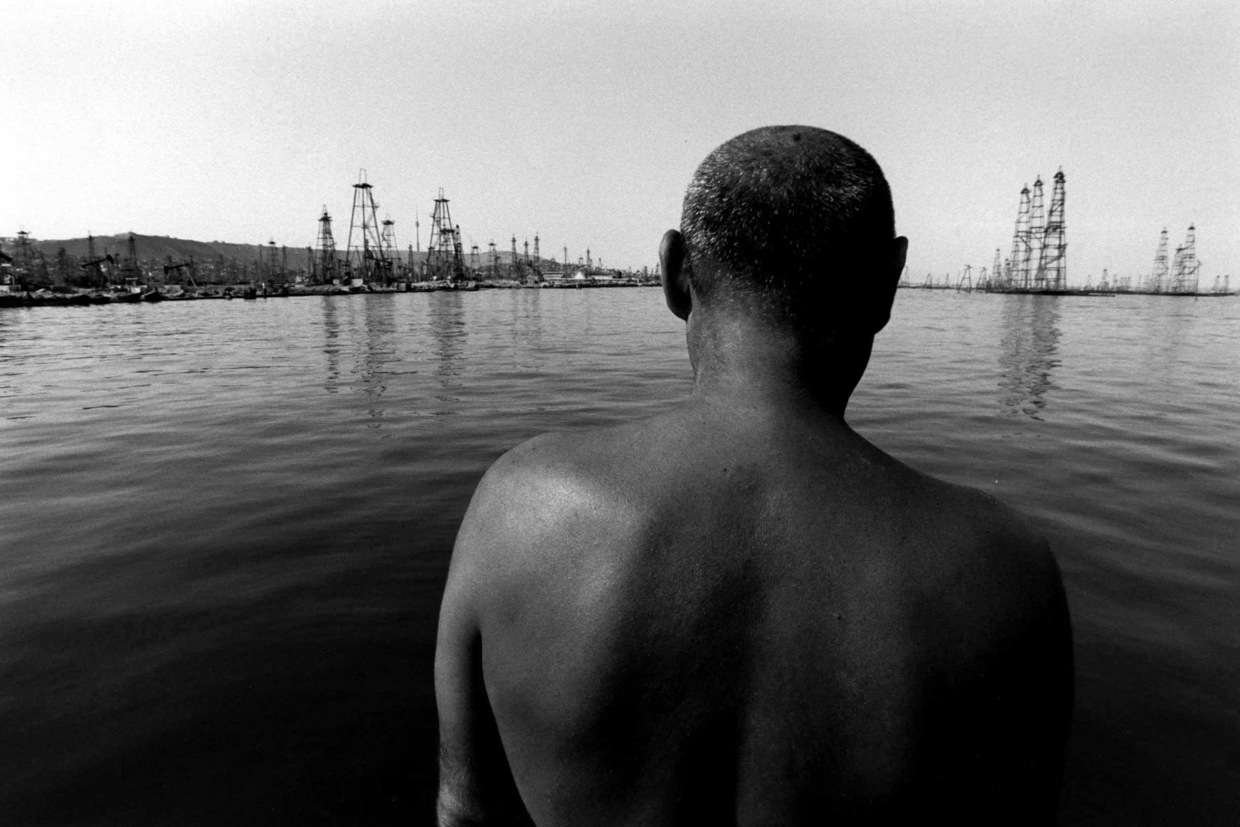 A fisherman pondering the lack of fish, due to the pollution of petrol. Bakou, Azerbaijan, 1998