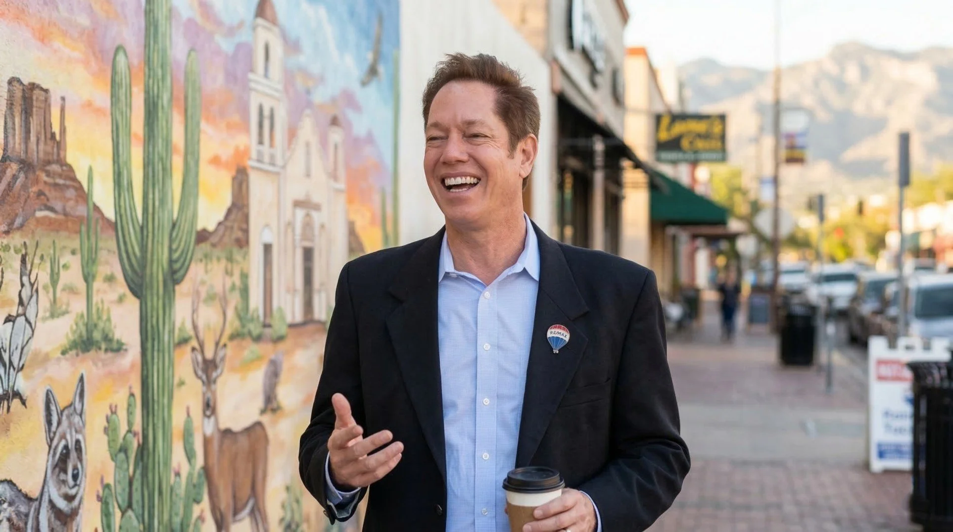 Tony Ray Baker Tucson Realtor standing outdoors in Tucson with desert architecture and murals, representing local real estate expertise.
