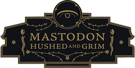 Logo for Mastodon Hushed and Grim, featuring black background with gold text and decorative elements.