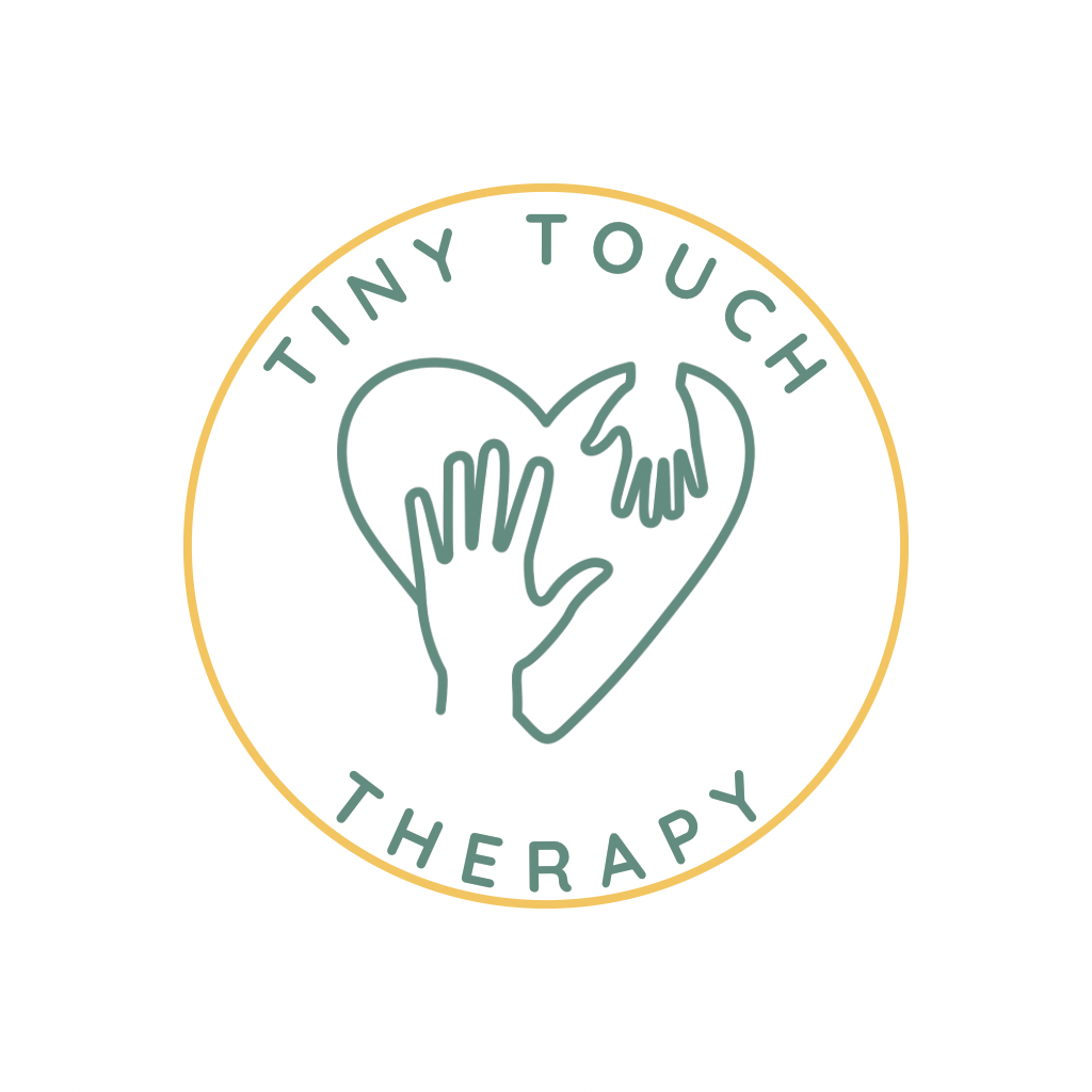 A circular logo with a gold border, featuring a heart shape formed by two hands and the words "tiny touch therapy" encircling it.