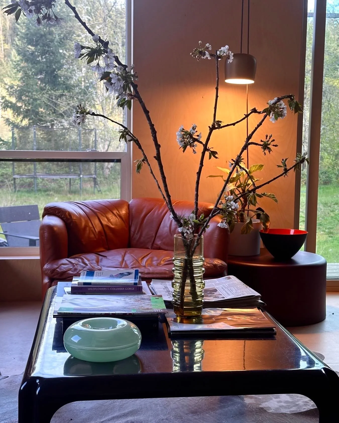 Pretty much sums it up:

Vintage furniture - 70s Italian leather chair #confidentialsaporiti and brown plastic #vicomagistretti coffee table by Artemide back when they made furniture

Italian lighting in warm tones: @flos Aim pendant by @ronanerwanbo