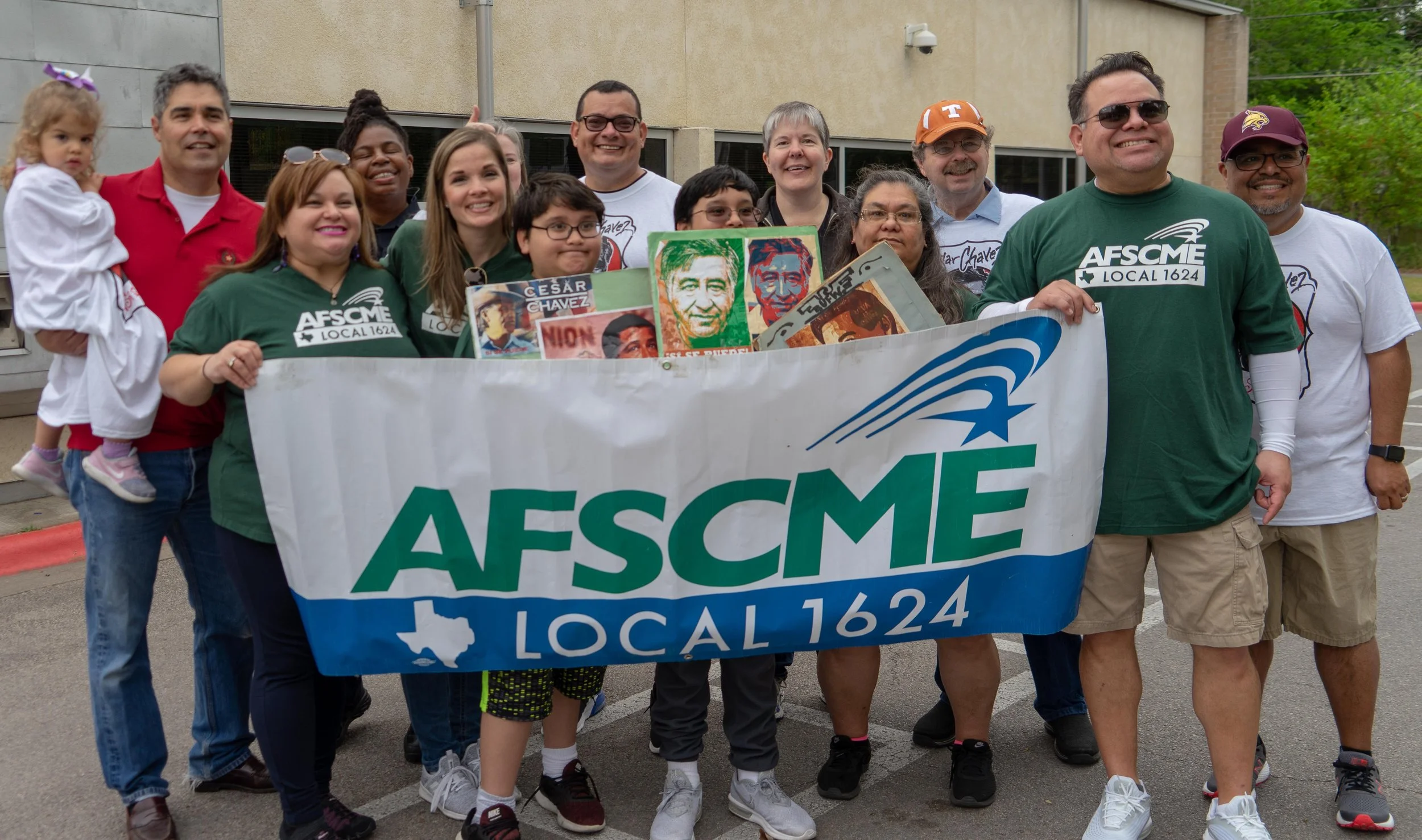 Group of people holding a large AFSCME Local 1624 banner during a labor union event.