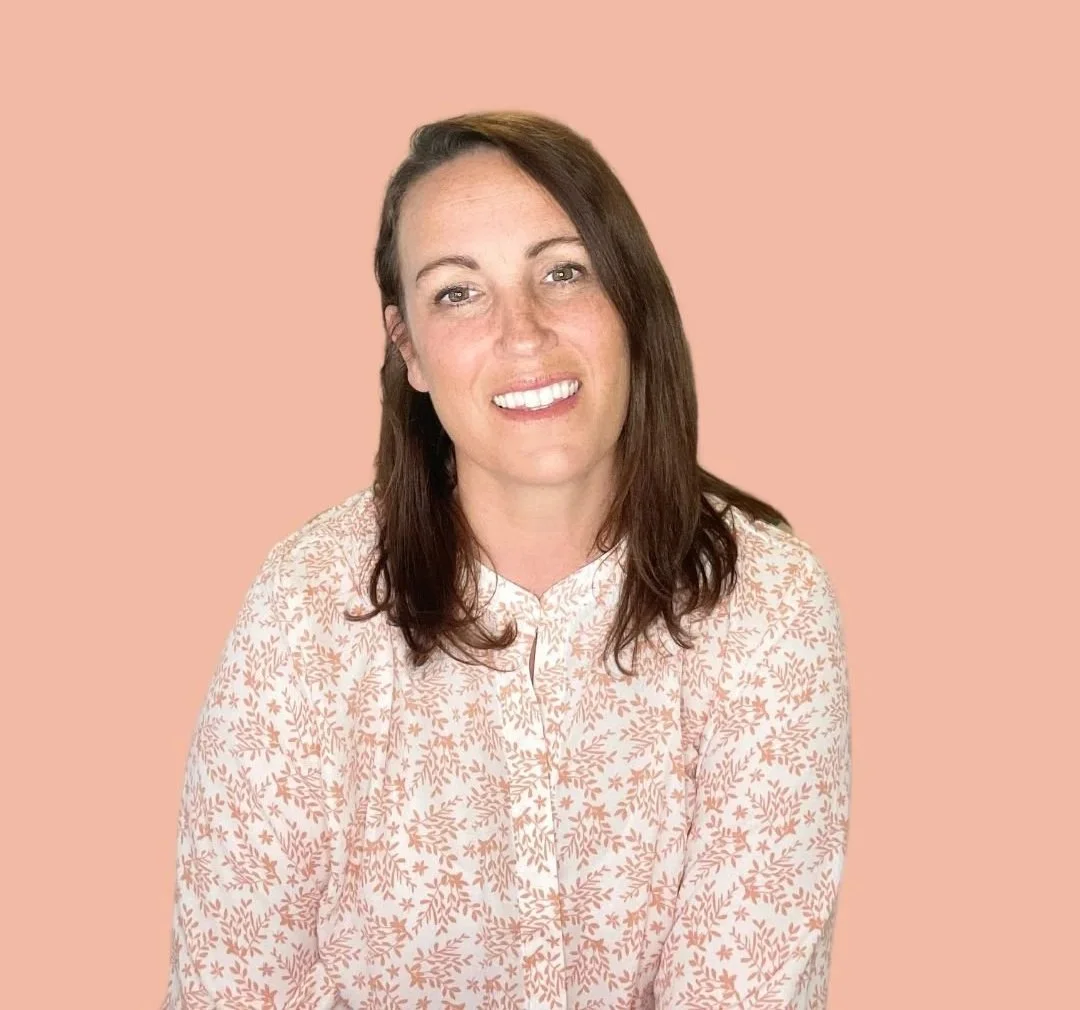 Melissa Morais Parr, a postpartum therapist with shoulder-length brown hair and fair skin, smiling, wearing a light-colored blouse with a floral pattern, against a peach background.