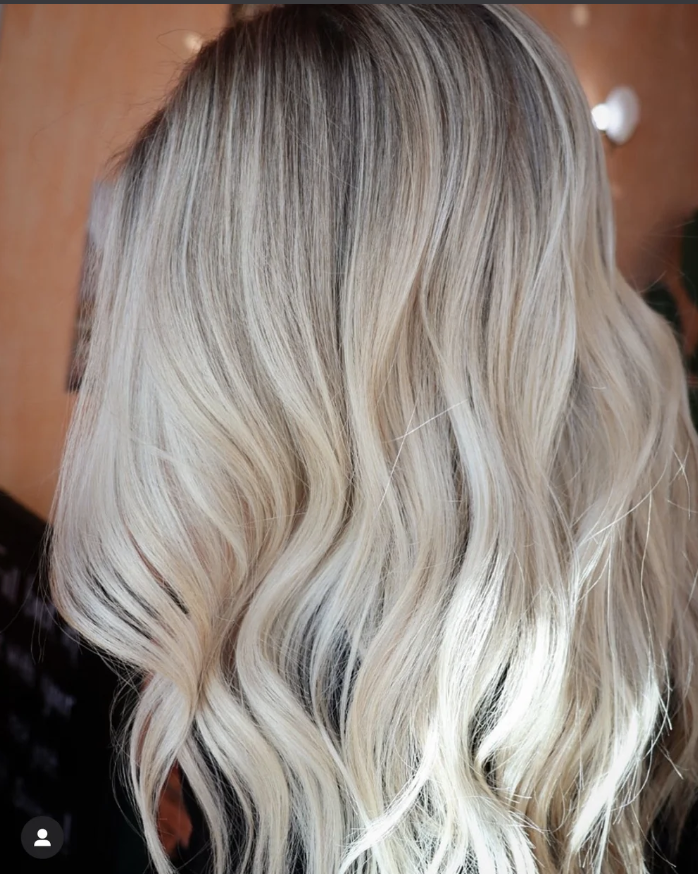 Close-up of wavy, blonde hair with highlights.