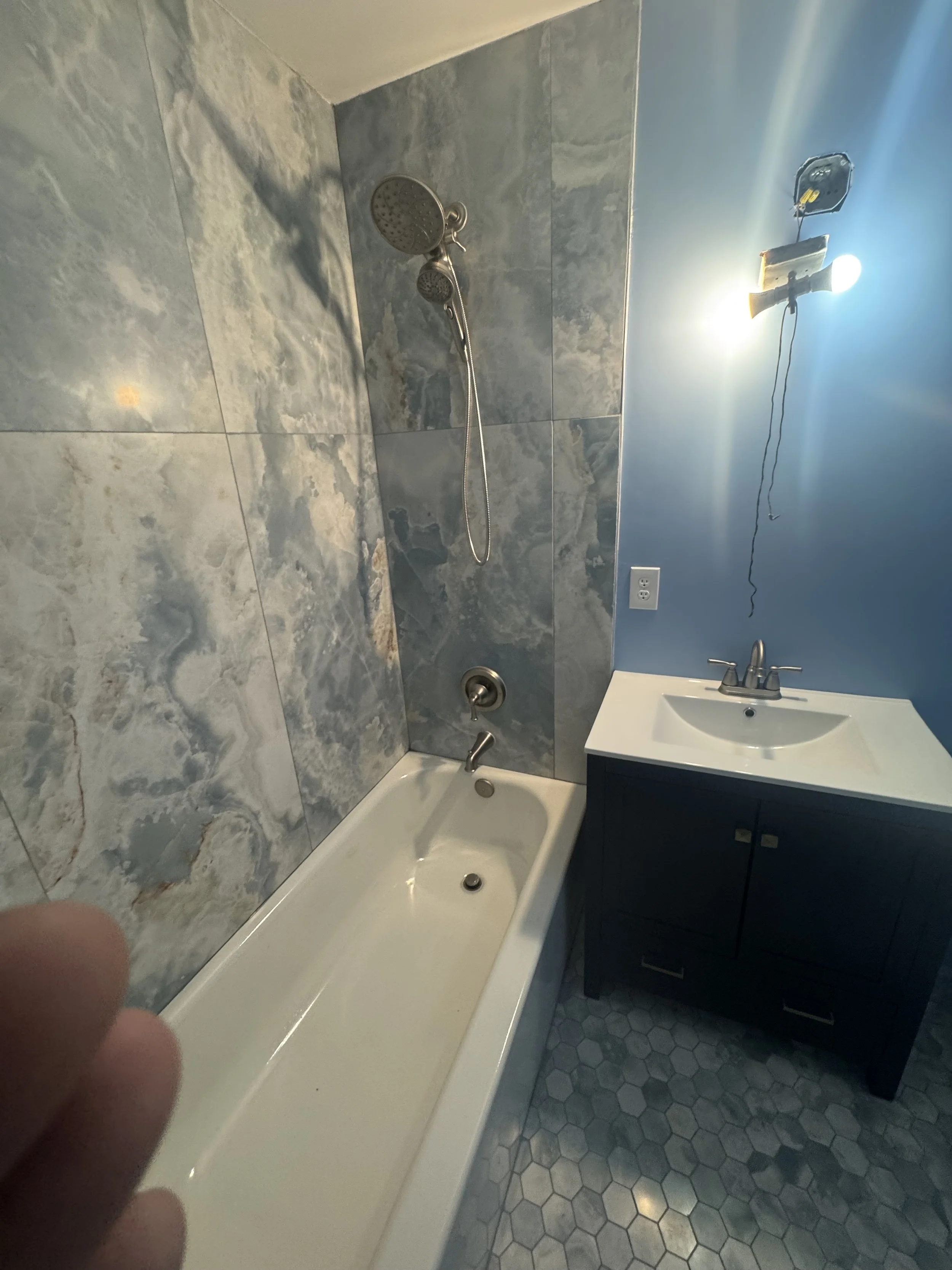 Plumber installing new shower fixtures during bathroom remode