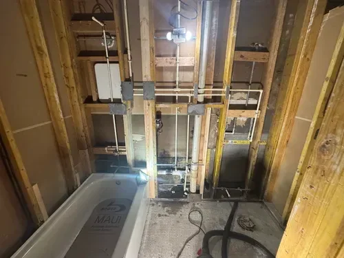 Bathroom repiping service replacing old water lines behind walls