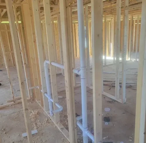 “New construction plumbing system being installed before walls are finished