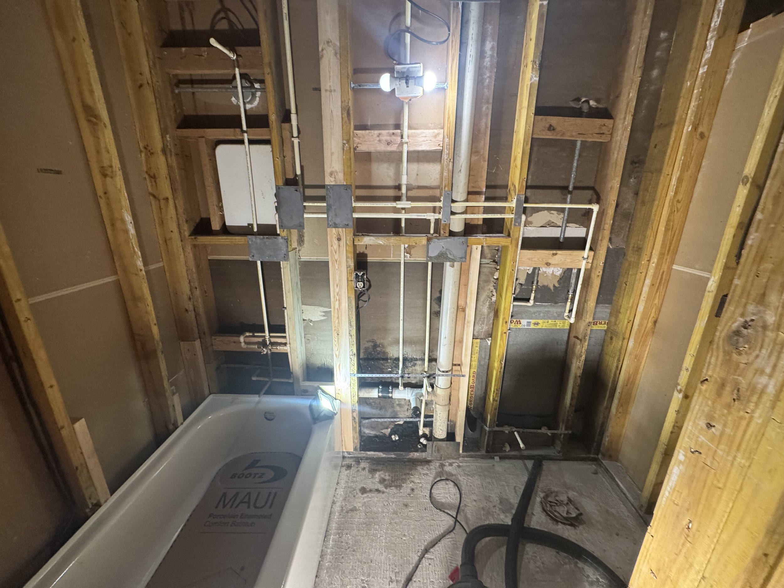 Bathroom repiping service replacing old water lines behind walls