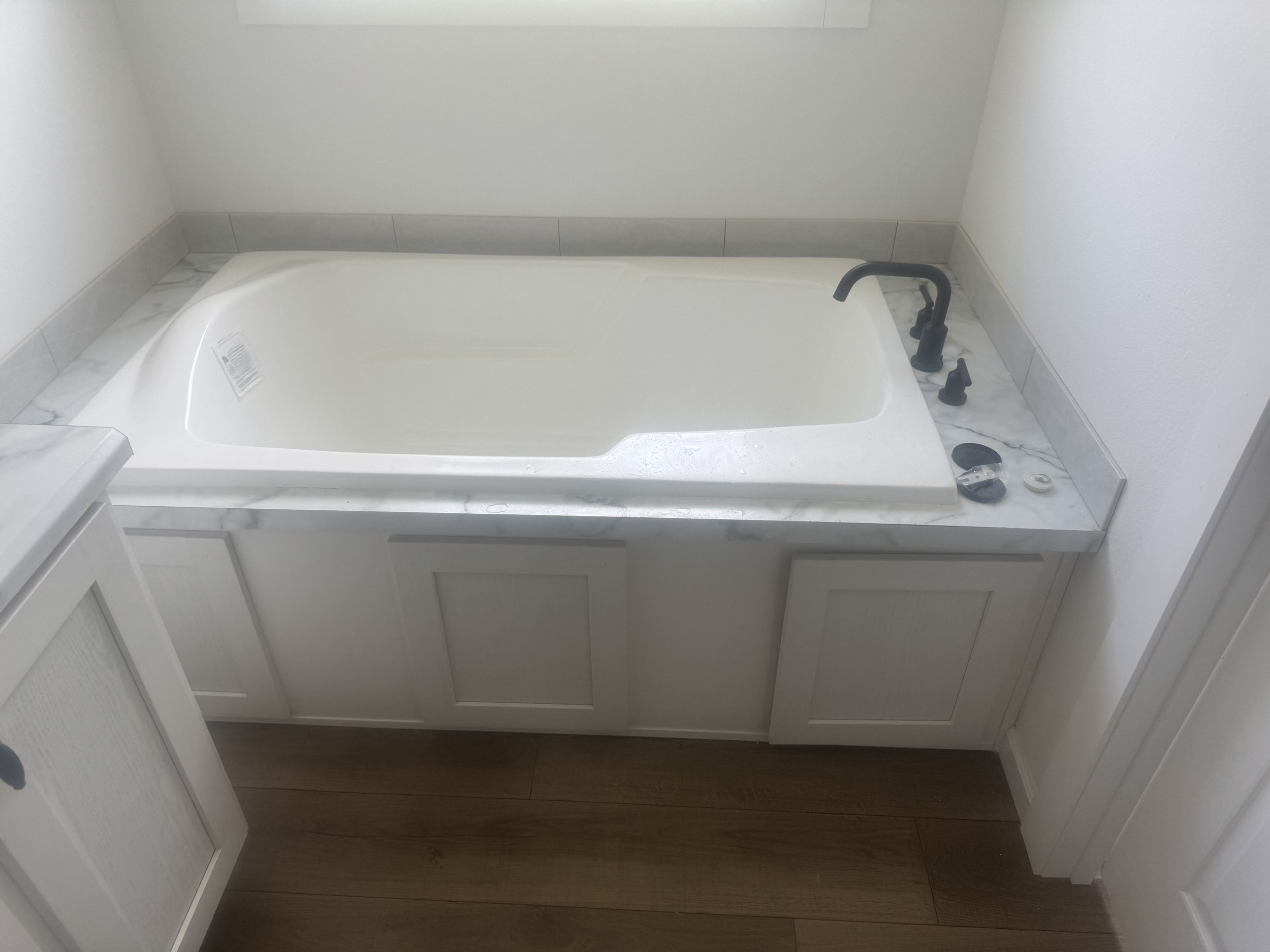 Code-compliant bathtub rough-in plumbing and overflow assembly for a new residential build.