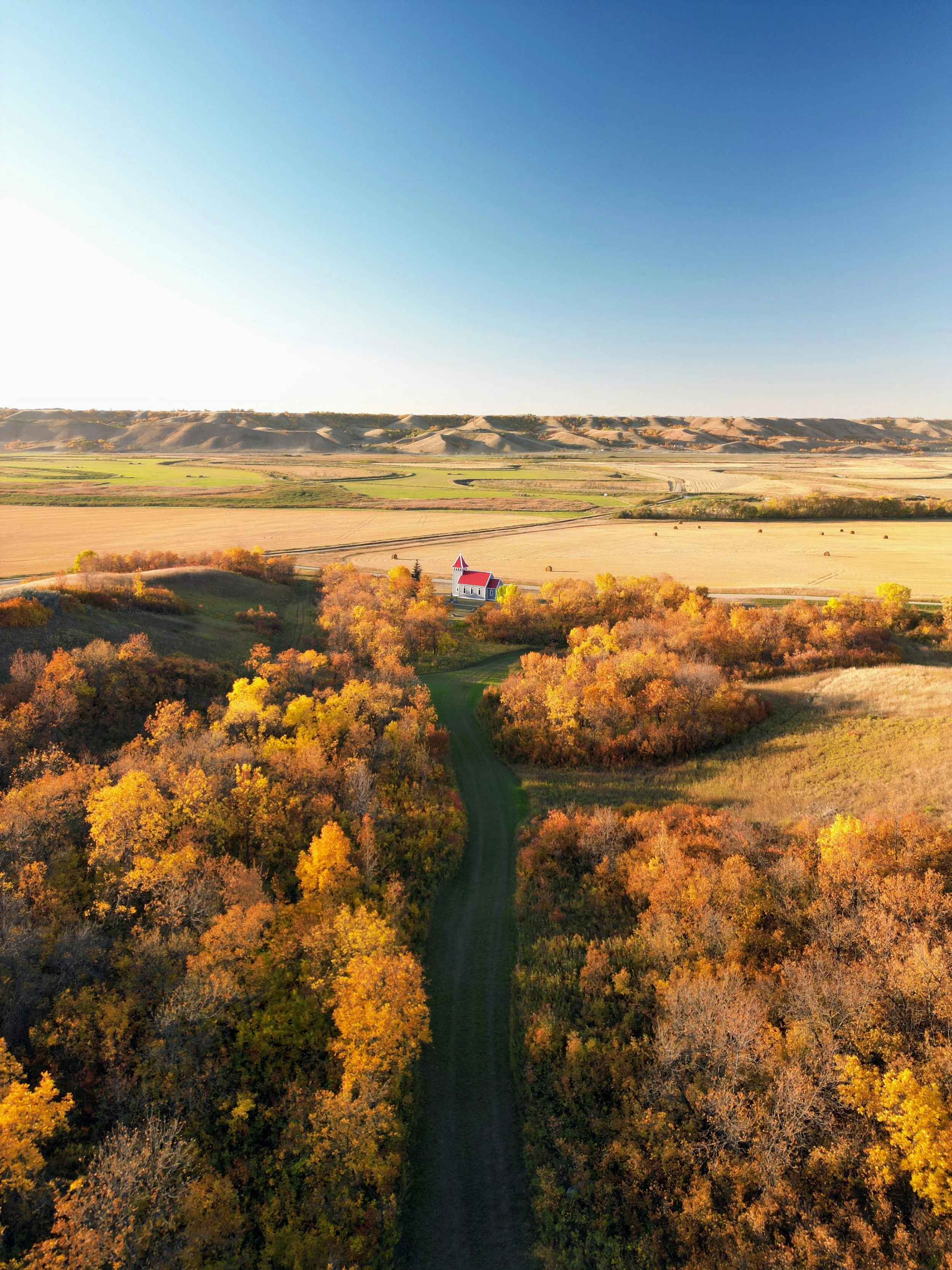 Aerial photo of fields and a small church in Craven, SK (credit: Ruvim Kerimov)