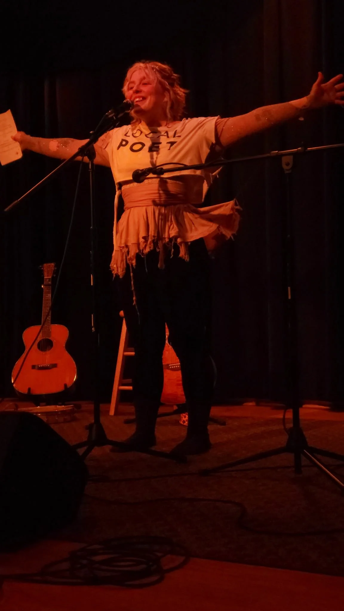 Earlie Grace Davis Kid Pixie stand on stage during a musical performance.