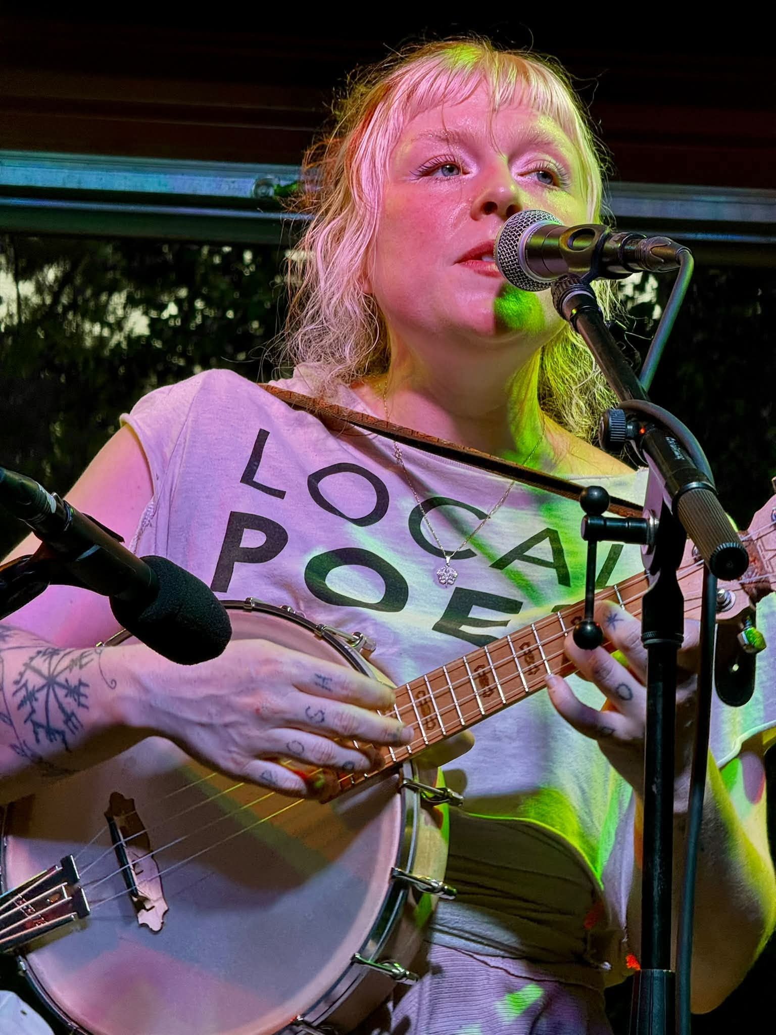 Singer Song Writer Earlie Grace Davis Kid Pixie sings during a live musical performance.