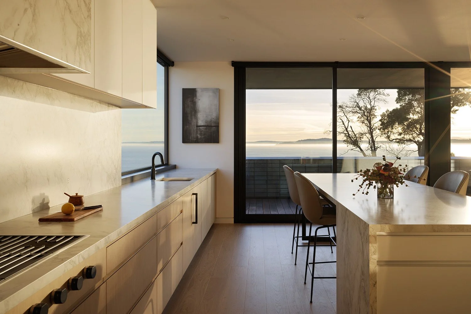 Kitchen with warm sunlight and views of the Salish Sea