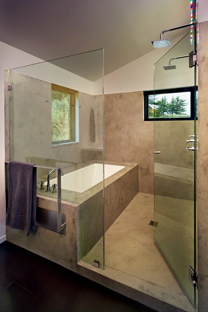 Warm Wet Room with plaster finishes, dual showers, custom towel bar and soaking tub