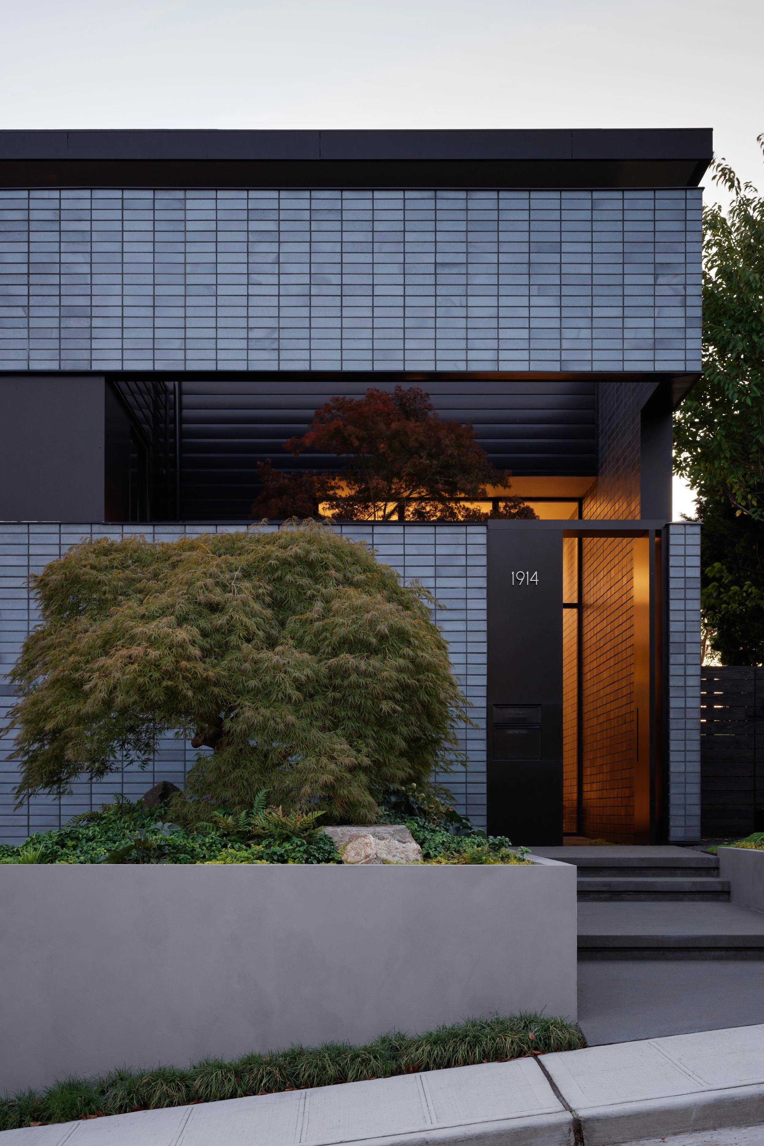 Custom steel gate at Entry to private courtyard with concrete planter