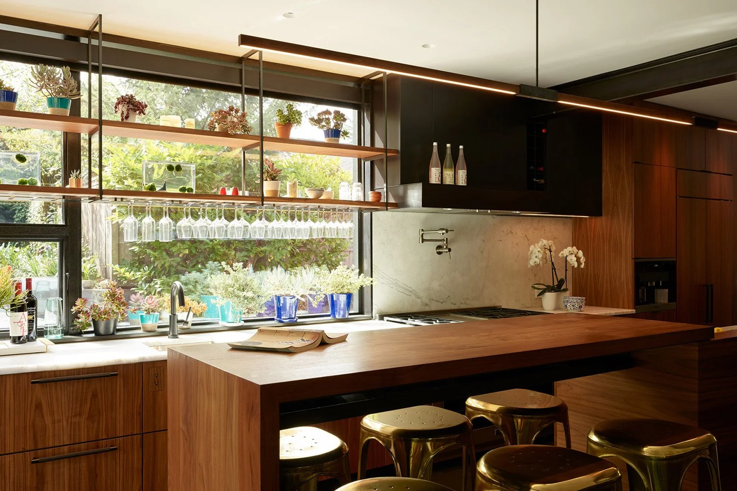Custom walnut bar counter with suspended shelving and bespoke glass racks