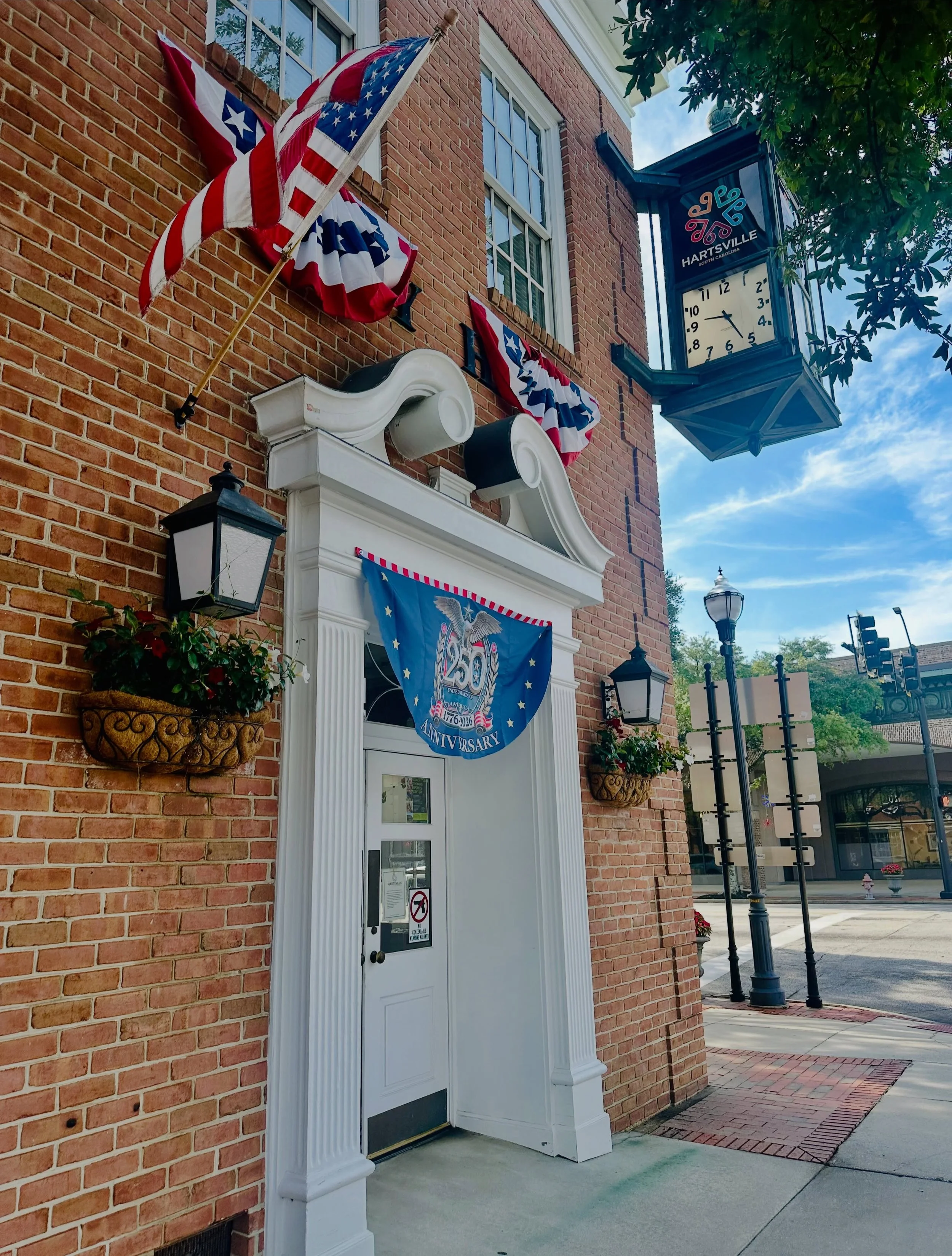 Red, white &amp; blue from the top down! #HartsvilleSC&rsquo;s City Hall is proudly dressed in patriotic spirit as we celebrate America&rsquo;s 250th. Be sure to stop by downtown and take in all the festive displays! #america250 #downtownhartsville #