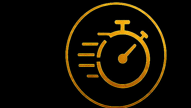 A gold-colored stopwatch with markings indicating speed or urgency, on a black background.
