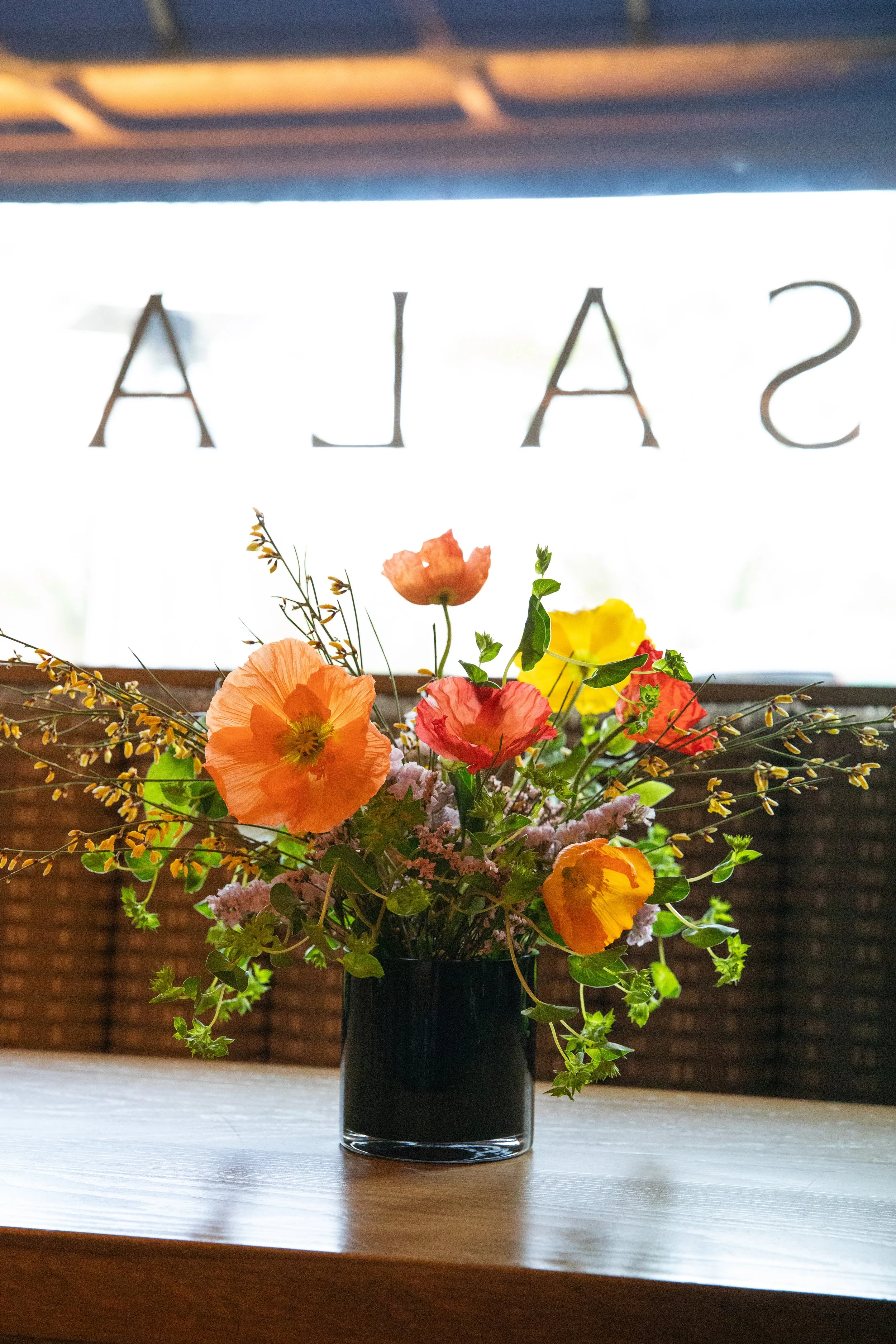 Flower arrangement with poppies at a Moxie CLT event held at Sala by Stagioni Charlotte NC
