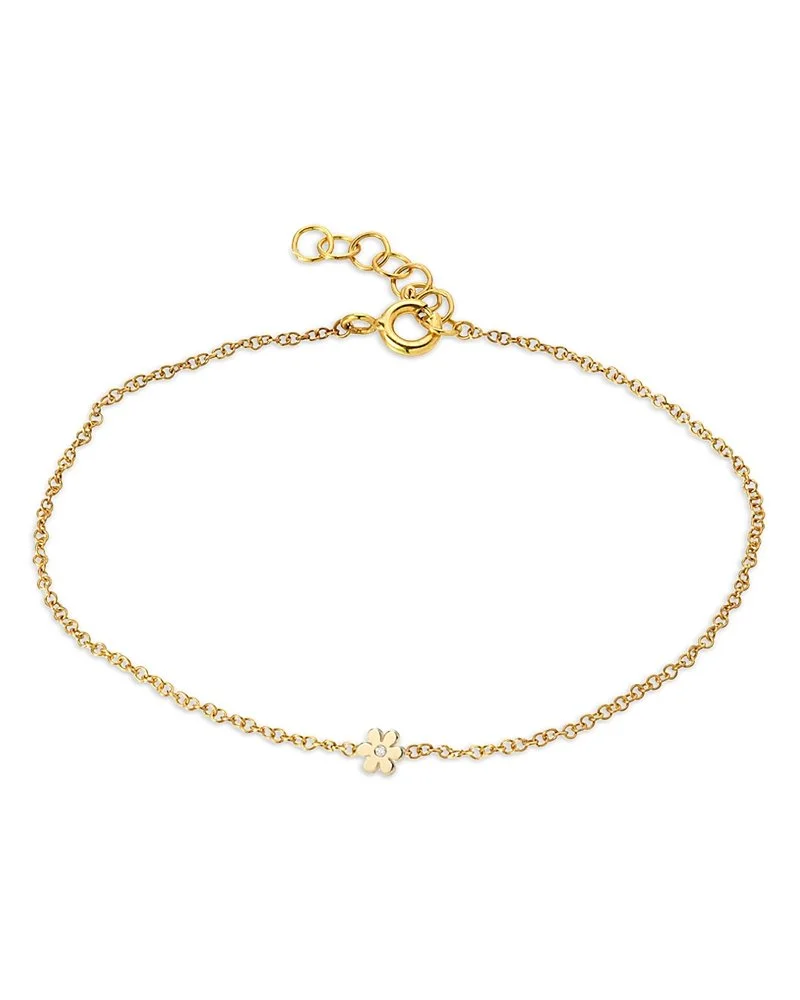 Gold necklace with a small flower charm and adjustable chain clasp.