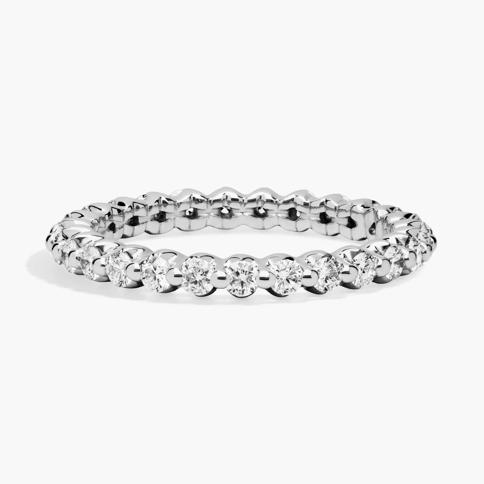A silver eternity ring with round-cut diamonds set all around.