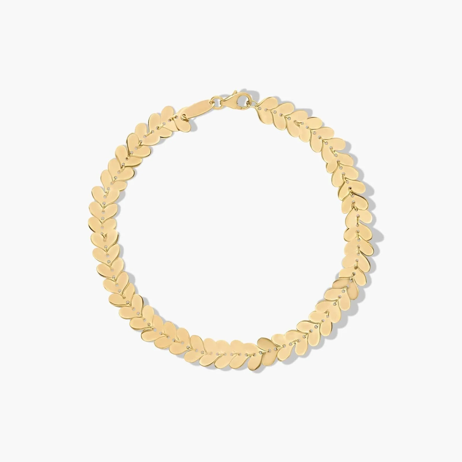 Gold chain necklace with leaf-shaped links on a white background.
