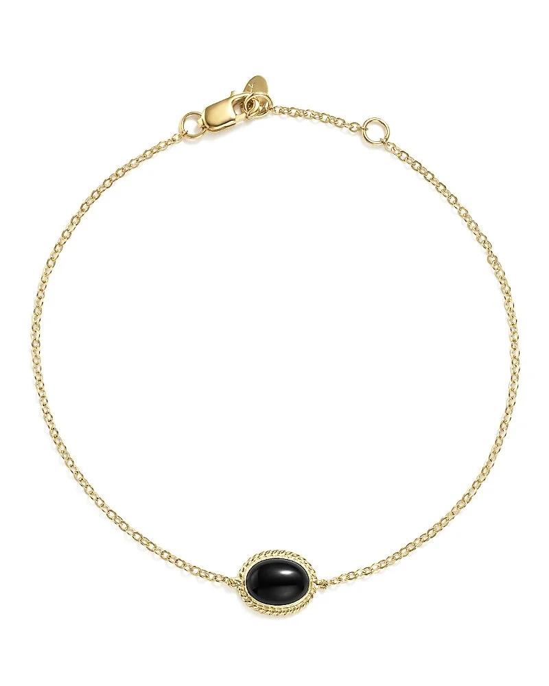Gold necklace with a black oval pendant.