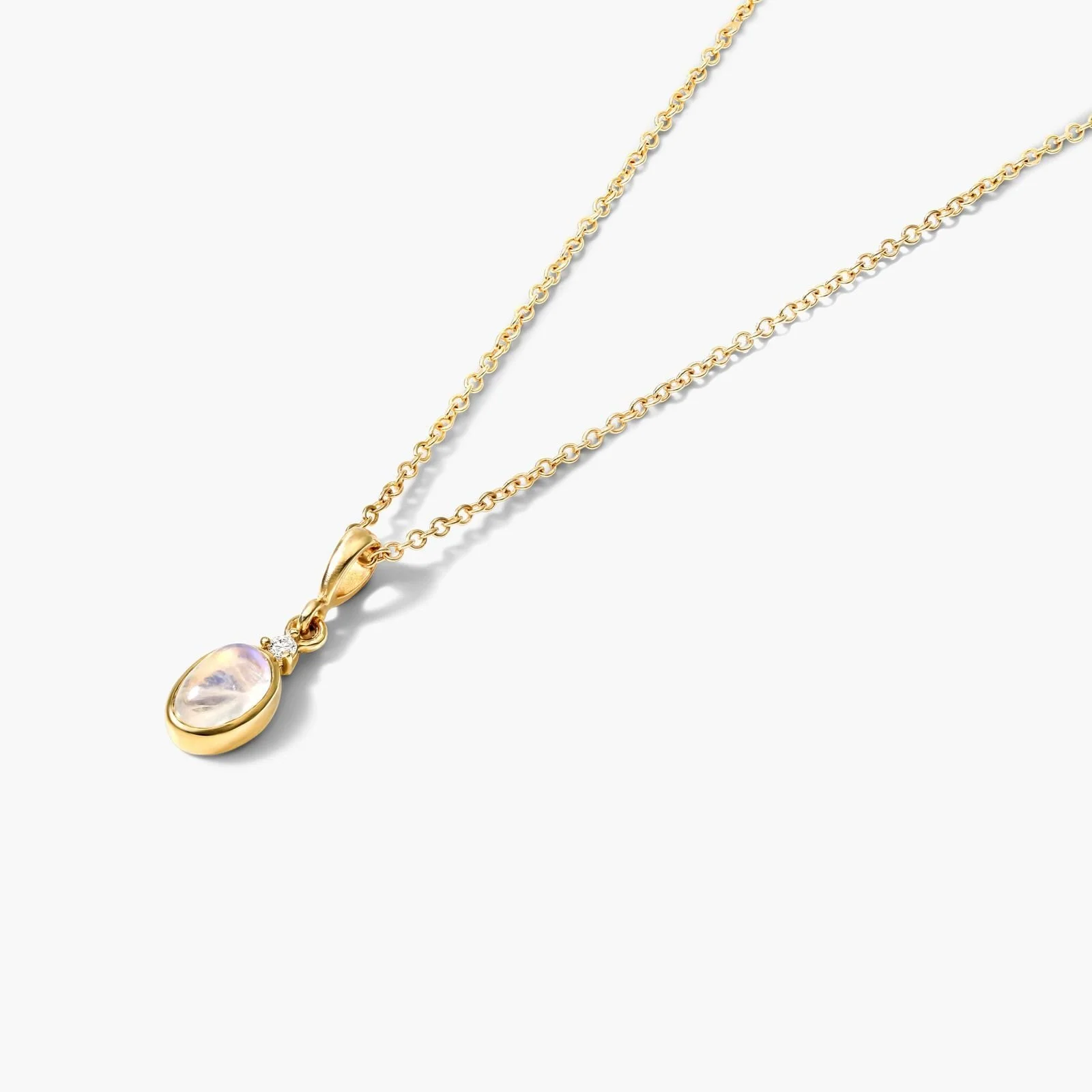 Gold necklace with a pendant featuring a moonstone and small diamond accents, against a white background.
