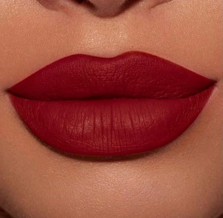 Close-up of lips wearing matte red lipstick. Sexy siren and outfit inspo and ideas