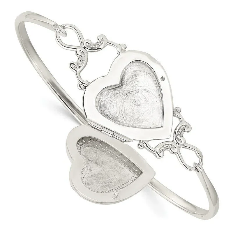 Silver bracelet with two heart-shaped lockets, one open and one closed, connected by decorative links.