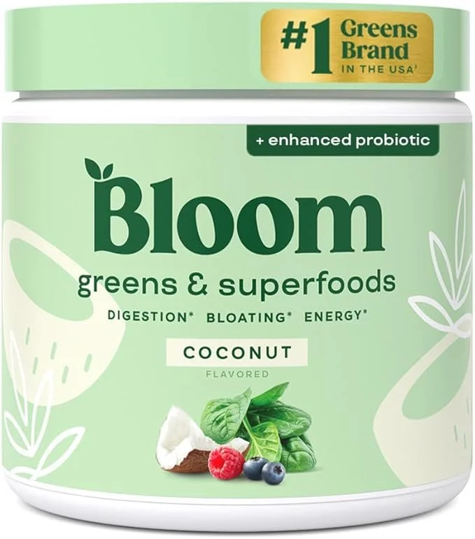 Container of Bloom greens & superfoods with coconut flavor, featuring a label highlighting probiotic benefits and the brand's ranking in the USA, with images of spinach, coconut, raspberry, and blueberries.